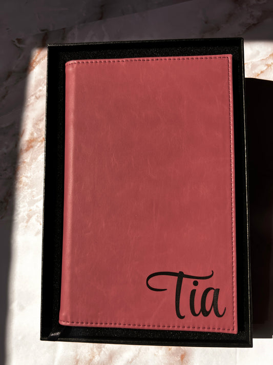 Pink leather-bound book with name embossed on it
