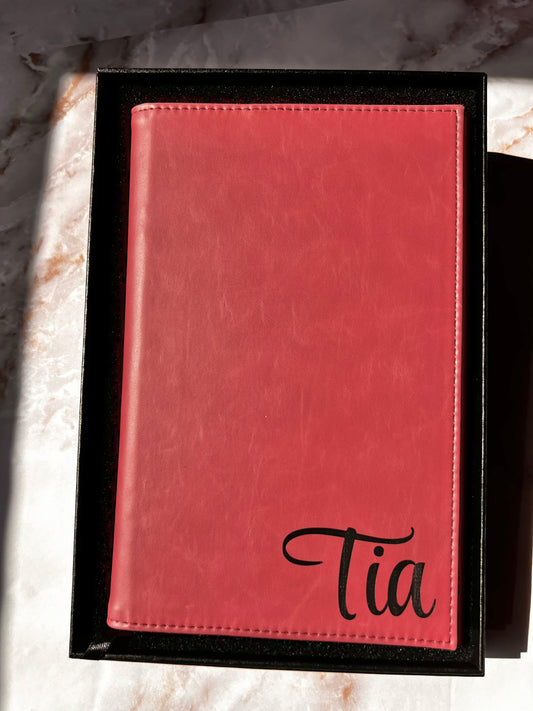 Pink leather-bound book with name embossed on it